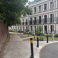 Continue past these modern houses as the road transitions to a pathway.