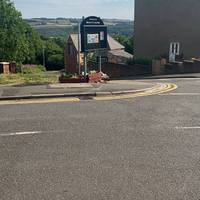 By the junction with South Rd, head towards the black sign. Continue downhill following the public footpath sign. Note this has a drop kerb.