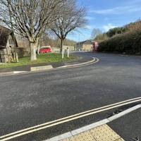 Turn left onto Gullock Tyning at the tactile paving drop kerbs.