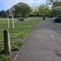 Continue past the bollards and onto the tarmac path via the drop kerb.