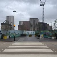 Outside the main exit on the right, cross over the zebra crossing.