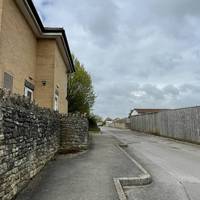 Immediately turn left to walk along the access road and small car park alongside the residential home. Take care around moving vehicles.