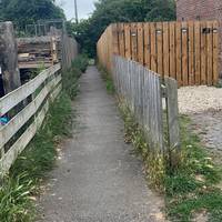 Turn left here on the narrow footpath between housing.