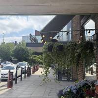 Outside the station entrance, turn right, walking past the florist and Waitrose.