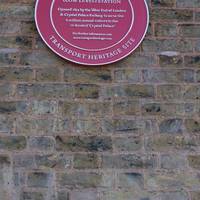 As you turn left out of the station there will be a red Transport Trust plaque.
