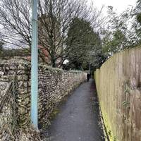 Continue towards the church, with the stone wall of the church grounds now to your left.