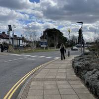 Follow the path to the right and then cross the zebra crossing to meet Windmill Road.