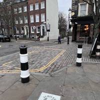 On the corner of Duncan Street, use the drop kerb to cross diagonally over to the other side. The cobblestone underfoot is uneven.