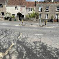 By the bus stop, use the traffic island to cross the main road, the A37, when safe to do so and turn left on the opposite side.