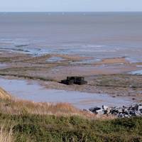 Down on the beach you will see a WWII pillbox that used to be located on the cliff top before coastal erosion caused it to fall down.