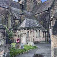 Enter the churchyard through the gate and walk behind the church