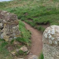 Head onto the coastal path and go through the gap in the wall