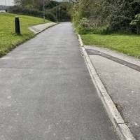 The path heads downhill.  At the bottom of the hill, note the mural in the subway on the left, but then turn right.