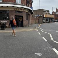 On the other side of the road, turn to your right and use the dropped kerb to cross over The Crescent.