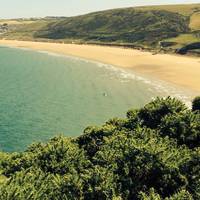 The view back towards the beach gets more beautiful as you follow the coastal path west, with the sea to your right.