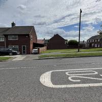 Wait for a break in the traffic and then cross. Up ahead you’ll see a path inbetween the houses.