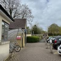 With your back to the entrance, turn left along the paved walkway, passing the pharmacy.