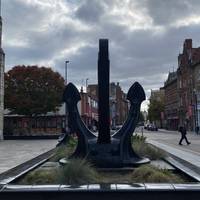 Look out for this old anchor and keep walking down the High St.