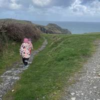 Go through the kissing gate and head down hill towards the coast. Keep left at the fork.