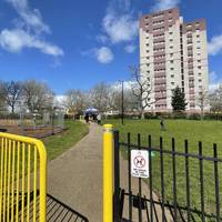 Turn right to head through the yellow gate and across the Barton Hill Urban Park on the tarmac path.