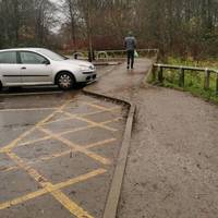 From the car park near the accessible spaces, follow the pavement out towards the road (Monton Green).