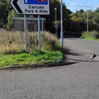 At the  entrance/exit at the Carluke park and ride sign, turn left onto Station Road and head downhill on a short section of pavement.