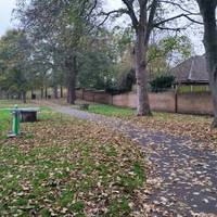 As the path bends to the left continue following the path passing the outdoor gym equipment to your left.