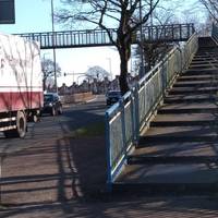 Take the steps up onto the blue foot bridge - look left for an interesting view of the docks!