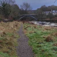 Admire the view from the carpark but don't take the path towards the river. Instead go out to the road, turn right and walk uphill