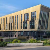 The university stands next to the gatehouse the modern design standing in stunning contrast.