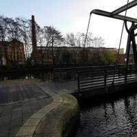 Don't turn right across the next bridge. Instead turn left along the wide canal-side path, ascending slightly.