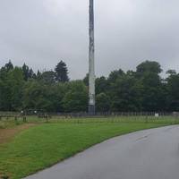 Walk around the fence surrounding the totem pole until you  reach the avenue that all the faces on the totem pole are turned towards.