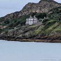 Continue east around the cliff road.  There is a Martello tower on a cliff top just as you are leaving the port area