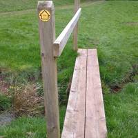 Follow the well trodden track across the fields to a small bridge across a stream.