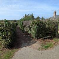 Take the hedged path past the Coastguard Cottages.