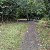 Walk towards the picnic bench and veer right