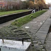 At lock number 3, turn right and cross the footbridge by the lock gate. The surfaces are slightly uneven here.