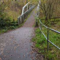 Soon cross a metal bridge, also hard-paved, high above the valley of the River Croal.